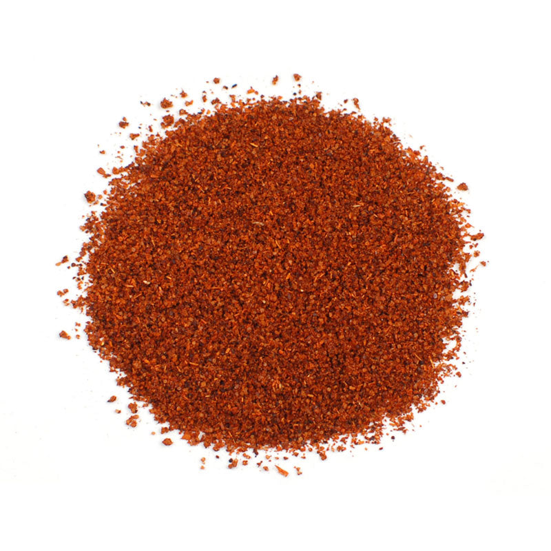 CHILI POWDER - 10 lb bag / box, vibrant red chili powder spread on a white background for seasoning dishes.