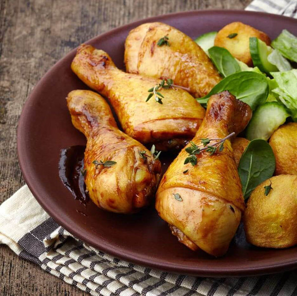 5 Easy Ways to Use Rosemary Sea Salt in Recipes - roasted chicken drumsticks with herbs and greens on a plate.