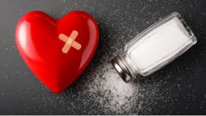 Salt and Heart Health: What Studies Reveal - image of a heart with a band-aid and a salt shaker.