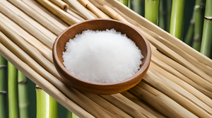 A wooden bowl filled with bamboo salt on a bamboo mat, showcasing What Is Bamboo Salt and How Is It Used?