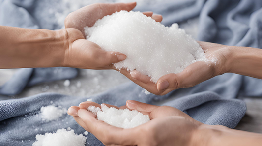 How Salt Can Help Remove Stains on Clothes - Hands holding salt over a cloth, showcasing salt's cleaning properties.