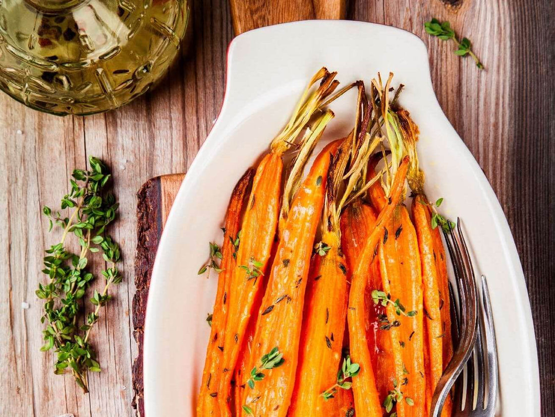 Five easy ways to use lavender sea salt in recipes with roasted carrots and fresh thyme on a wooden table.