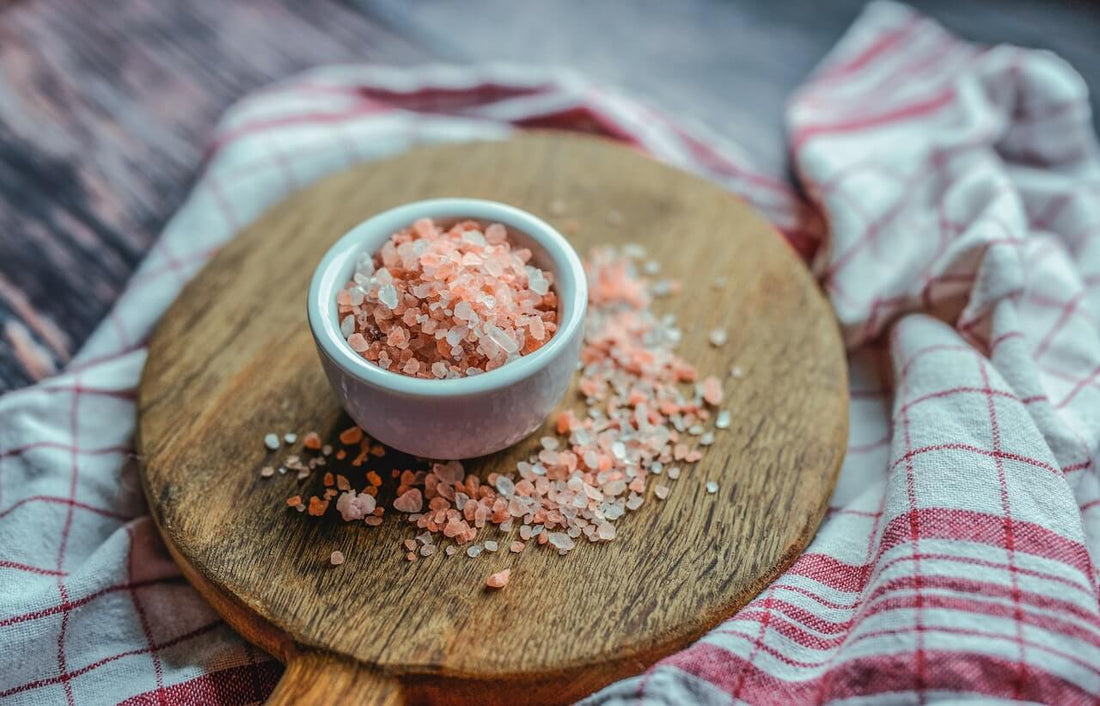 Breaking Down the Health Benefits of Himalayan Pink Salt in a bowl on a wooden board.