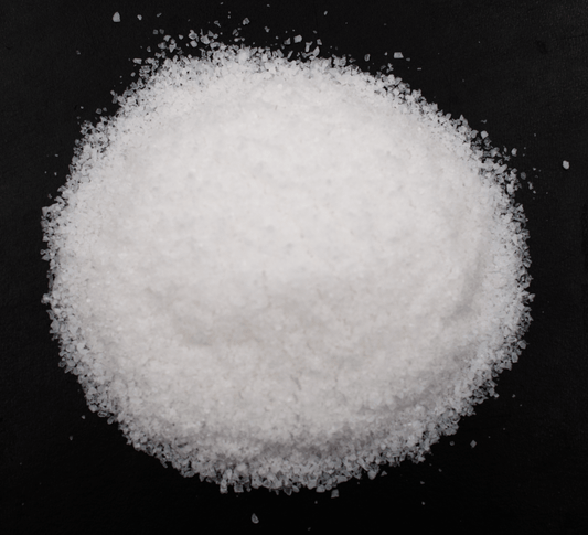 Salt Samples Pack Request - a heap of fine white salt on a dark background for sampling.