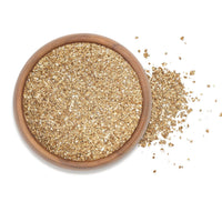 Smoked Garlic Sea Salt in a wooden bowl, showcasing its rich texture and color, perfect for enhancing recipes.