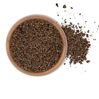 Triple Smoked Sea Salt in a wooden bowl, showcasing its robust flavor and texture.